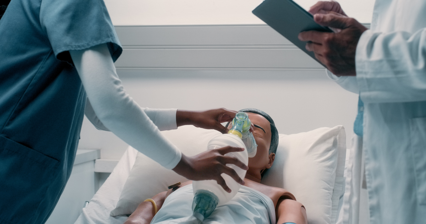A Nursing Student Uses a Resuscitator Bag on a Medical Manikin